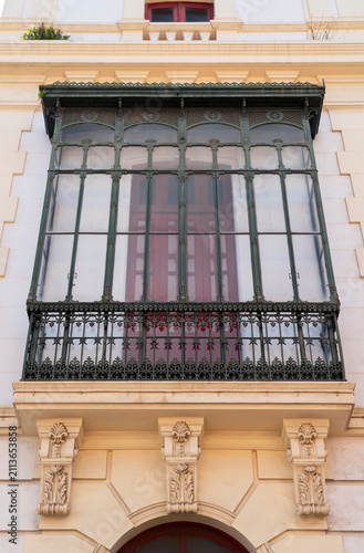 Ornate glazed balcony with wrought iron railing on colonial building, La Laguna, Tenerife