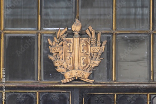 Obraz na plátně Only Unity Saves the Serbs or Samo Sloga Srbina Spasava motto on bronze emblem of SAN Serbian Academy of Sciences showing cross with four Cyrillic C firesteel letters on window frame