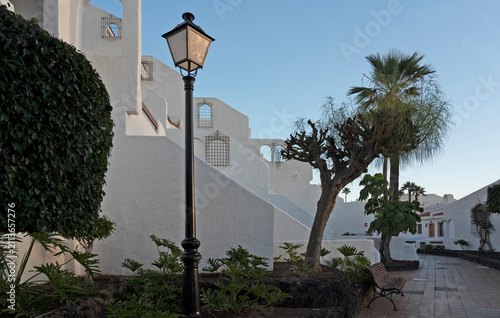 White resort apartment complex with terracotta walkway in Los Cristianos, Tenerife, Canary Islands