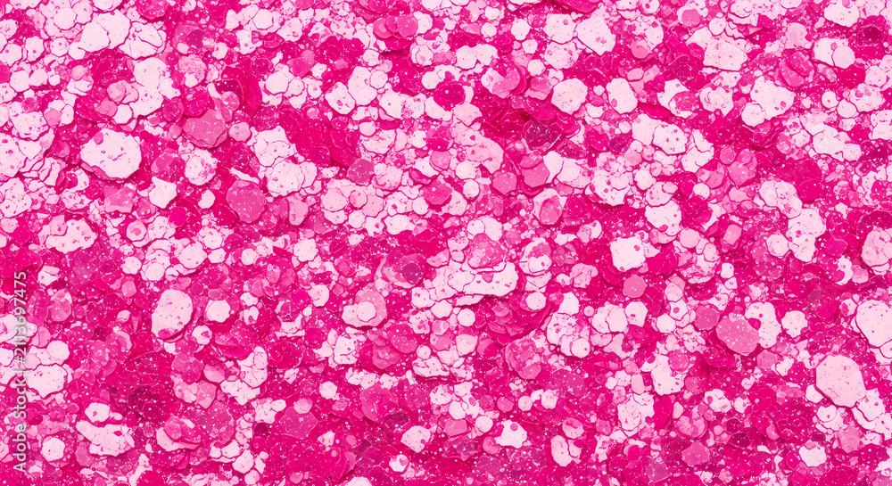 Obraz premium Abstract background featuring vibrant pink and light pink glitter particles.