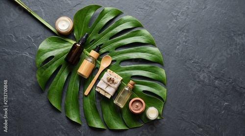 Natural organic skincare products are elegantly arranged on a large, vibrant green monstera leaf, symbolizing purity and a connection to nature.