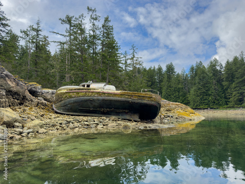 Old boat shipwrecked on an island