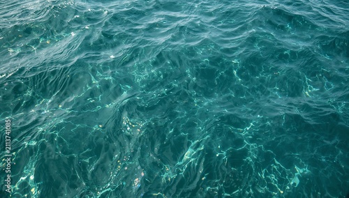 Water Surface Reflects Light Over Submerged Rocks in the Sea