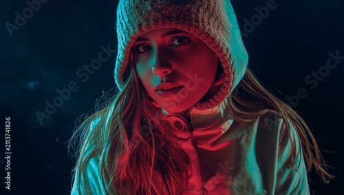 Woman With Long Hair Wearing a Hooded Jacket in Colorful Light