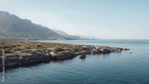 Coastline View With Mountains and Calm Water in the Early Morning Light
