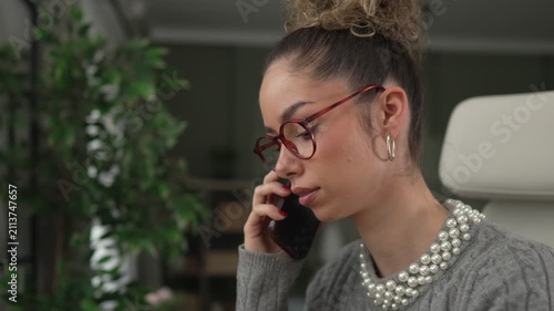 Focused businesswoman talking on the phone in office