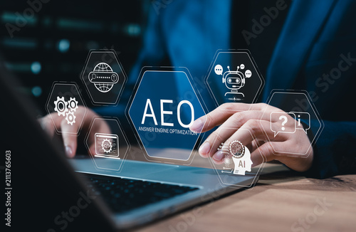 Answer engine optimization concept. Person using laptop and AEO interface to improve AI search visibility, chatbot response, semantic content, website discovery, digital marketing business performance