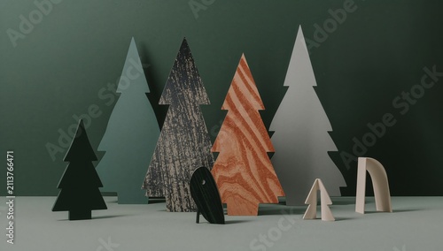 Wooden Trees Arranged on a Table Against a Green Background