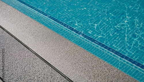 Sunny Day by the Swimming Pool With Clear Water and Textured Surface