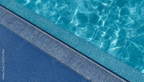 Sunny Day by the Swimming Pool With Clear Water and Textured Surface