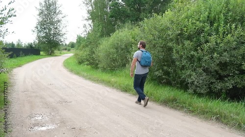 Active man jogging on a country road in summer field. Athletic male running outdoor, enjoying fitness workout, cardio training, and healthy lifestyle in countryside green nature theme. Self Discipline