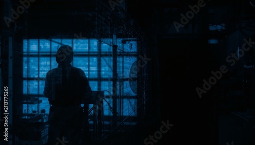 Light From the Window Shines on a Person Working in a Dark Environment During...