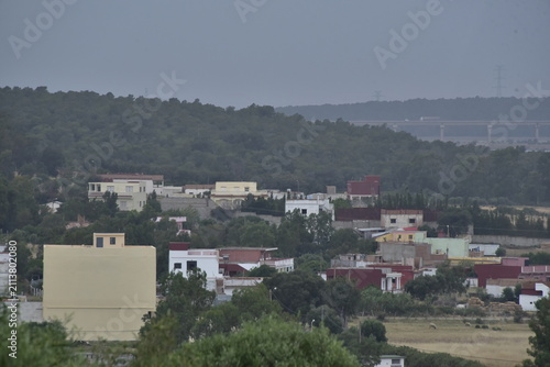 Maisons à côté d'une colline boisée en fin de journée à Hjar Hennahah au Maroc 