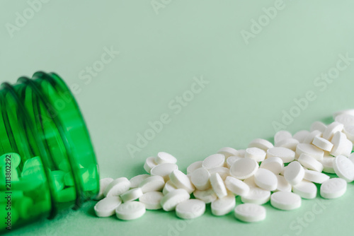 Green pills on white background