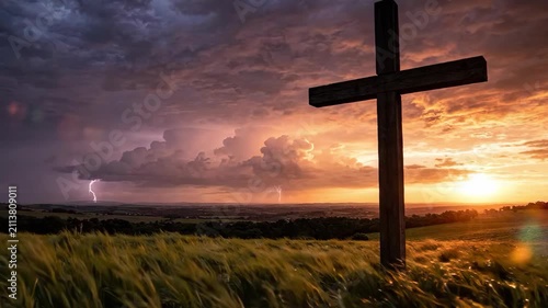 Dramatic Sunset with Cross on Hilltop, Symbolizing Hope and Faith.