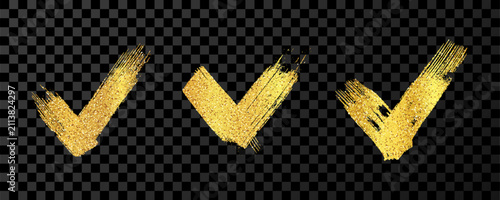 Set of gold grunge brushstrokes in the shape of a check mark