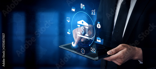 Canvas Print Businessman Using Tablet with Digital Banking Icons and Technology Concepts in Modern Office Environment