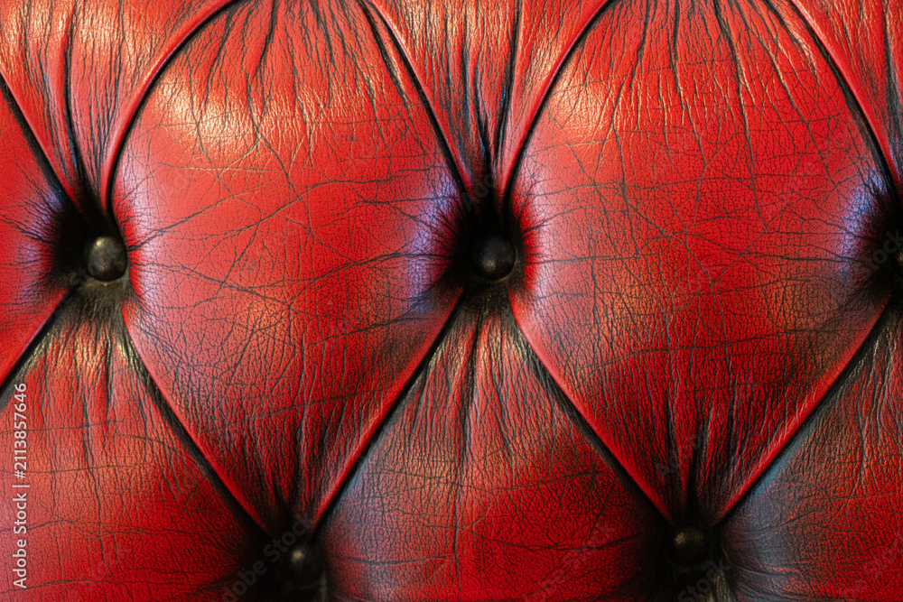 Obraz premium Close-up of classic tufted red leather furniture with button tufting