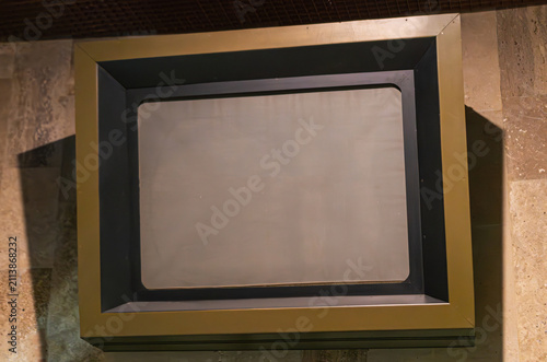 Canvastavla An empty rectangular display frame mounted on a textured, tiled surface