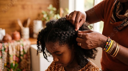 Generational Bonding Over Hair Braiding: Close-up on hands tenderly braiding a child's hair, showcasing a moment of connection and tradition within a warm, home environment.