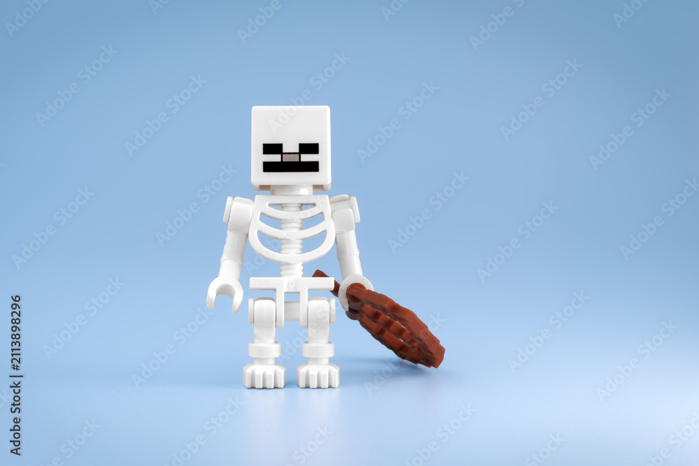 Fototapeta premium Minecraft Skeleton toy figure stands beside a brown Bow resting on the floor against a light blue background on Jul 25, 2026 in Jakarta, Indonesia