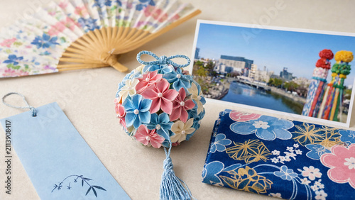 Japanese star festival arrangement with tanabata paper wish tag, floral temari ball, folding fan, postcard, blue patterned fabric, summer matsuri decor, colorful streamers, Sendai Tanabata