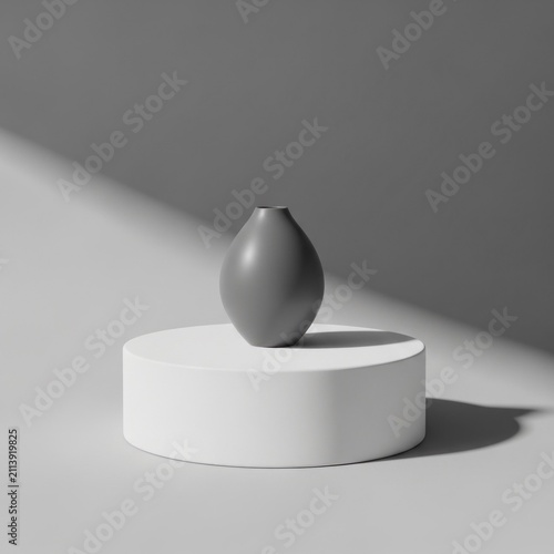 Minimalist grey vase rests on a white cylindrical pedestal against a neutral background.
