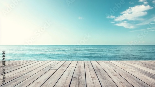 Serene ocean view from wooden deck; tranquil blue water under bright sky
