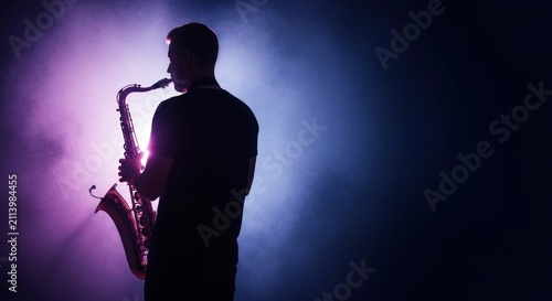 Silhouette of man playing saxophone music.