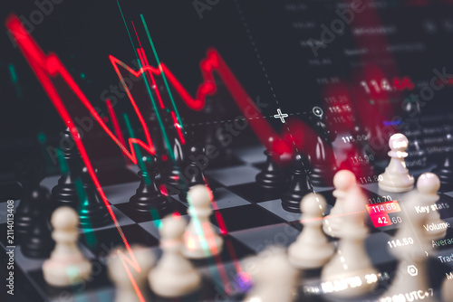 Stock market crash and financial crisis concept showing a chess board with a steep red downward trend line chart overlay