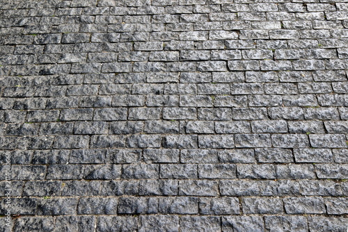 Quadro su tela Old cobblestone street pavement texture made of grey stone blocks
