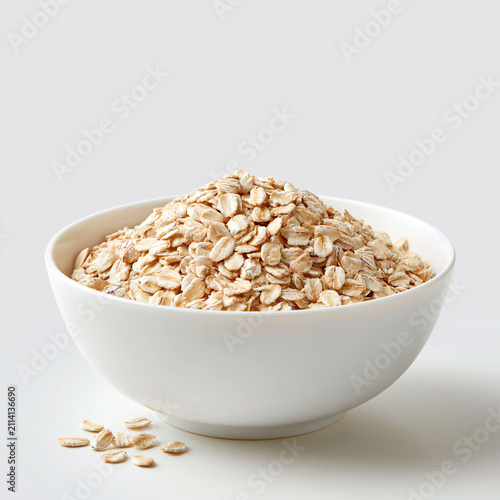Raw rolled oats in white ceramic bowl food preparation