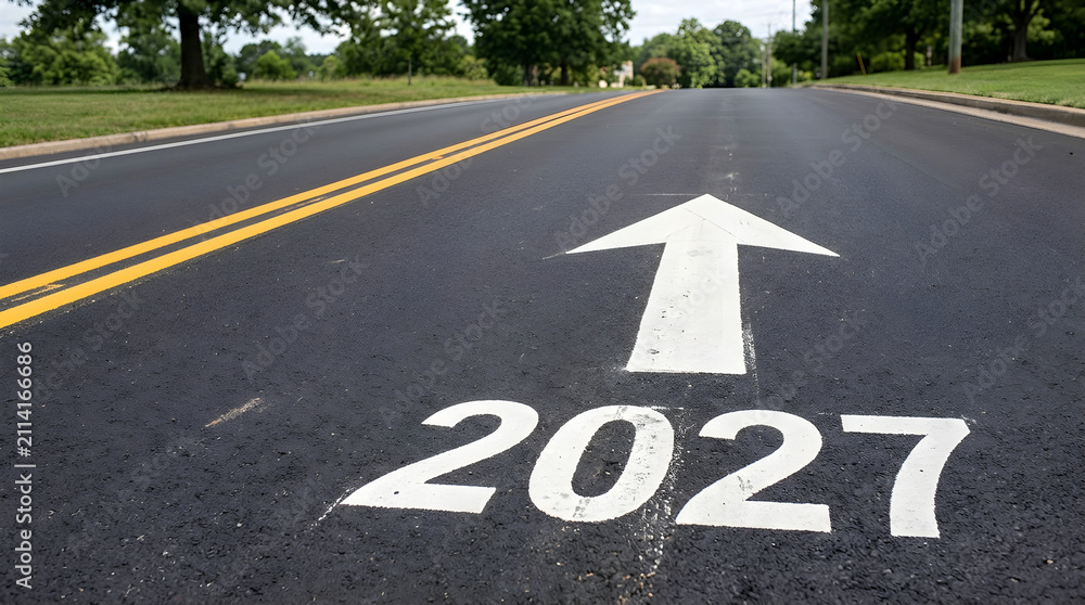 Fototapeta premium Year 2027 painted on an asphalt road with a direction arrow. This image represents future planning and new business goals.