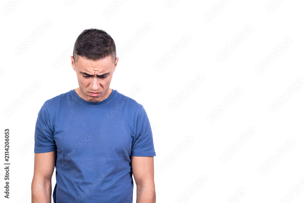 Obraz premium Man looking down while standing with sad expression