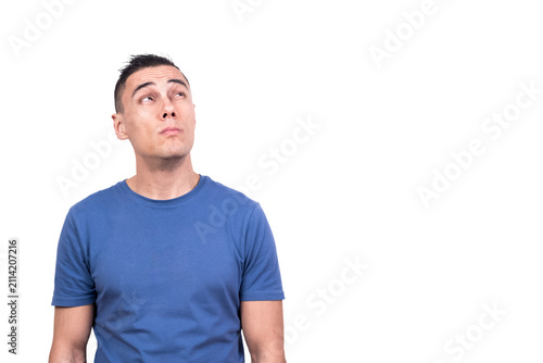 Fotografía Man standing looking up with distrustful expression