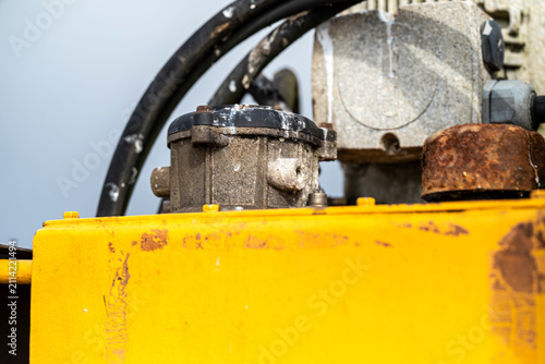 Картината върху платно Yellow heavy machinery and motor parts The Concept of industrial equipment