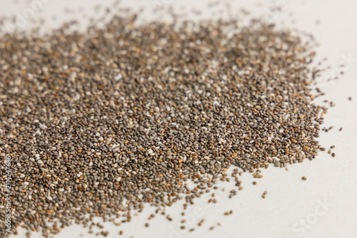 Konstfotografi Chia seeds on a flat surface showing texture and color variations during midday