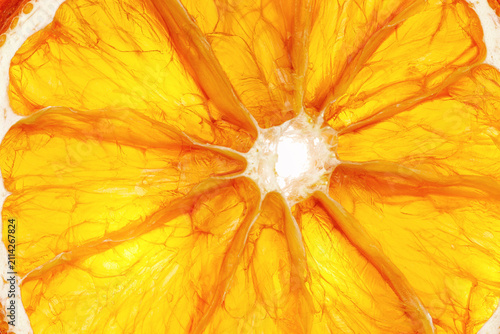Fresh round orange slice close-up showing juicy golden segments and white center. Vibrant and healthy citrus fruit detail, Minimal food pattern. Vegan, organic, clean eating, and fresh juice concepts.