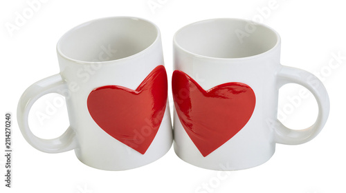 Foto Two white ceramic mugs with red hearts, isolated on transparent background