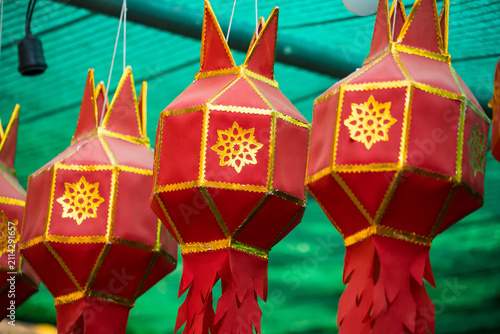 Red Lanterns Festival: A row of vibrant red lanterns, adorned with intricate golden patterns and tassels, hang suspended, creating a festive and magical ambiance.