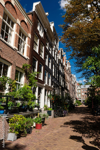 Picturesque residential street with traditional Dutch houses in Amsterdam