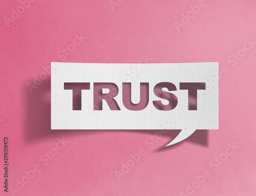 Paper speech bubble with trust text cutout on pink background, confidence and reliability concept