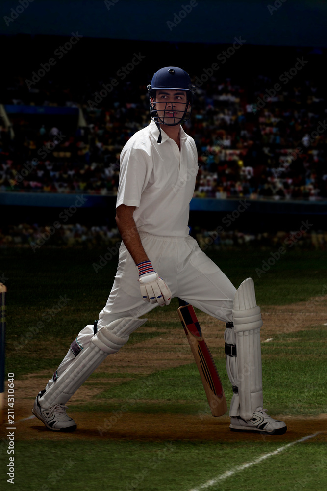 Obraz premium Full length of batsman stretching on cricket field 