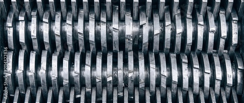 Close up of industrial paper shredder machine blades creating destroyed documents into small strips ready for recycling or disposal.