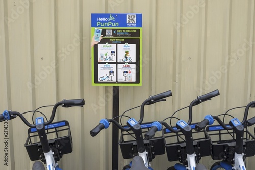 A series of Hello PunPun rental bikes, the blue and white wheels are properly available and show the modern, app-based bike sharing in the historic city center, station in the Phra Nakhon district, Bangkok, Thailand