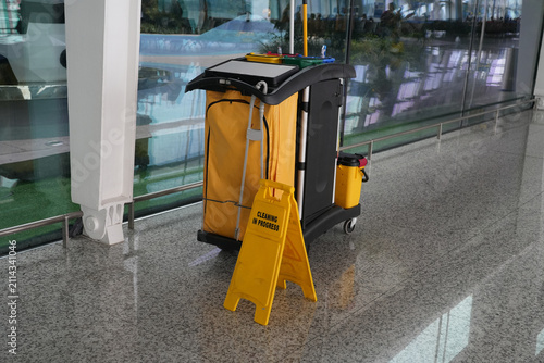 custodial cart with cleaning equipment and supplies in airport