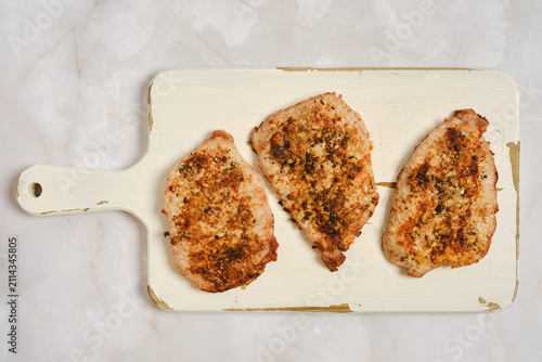 Juicy pork chops on cutting board ready for serving at dinner time