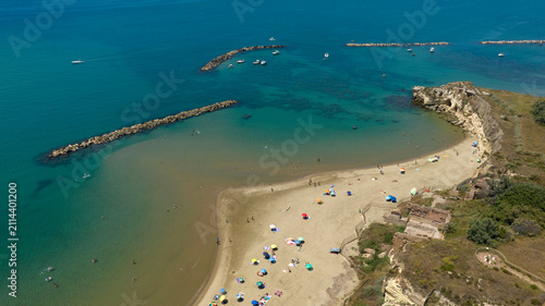 Konstfotografi Aerial view of Grotte di Nerone Beach in Anzio, Italy, showing the sandy cove with beach umbrellas, adjacent to ancient Roman ruins and sea caves, and protected by breakwaters in the Tyrrhenian Sea