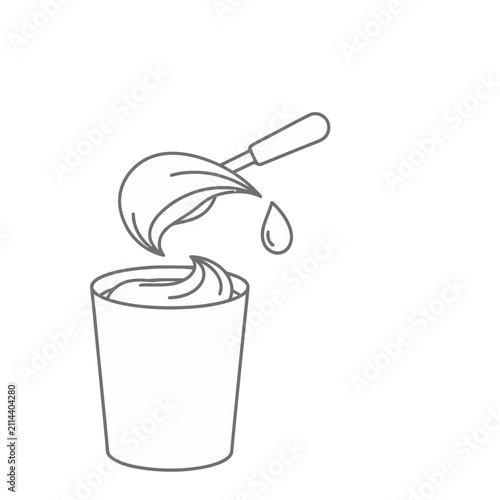 Spoon with cream dropping into a cup