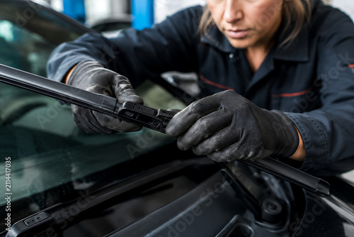 Woman Replacing Car Windshield Wiper Blade Close Up
